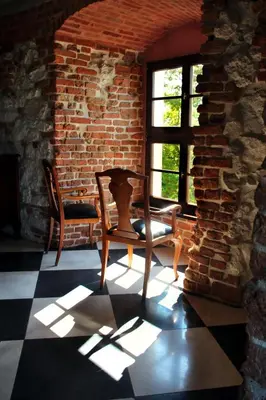 a room with two chairs and a window at Dom Gości Opactwa Benedyktynów in Tyniec