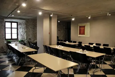 a restaurant with tables and chairs in a room at Dom Gości Opactwa Benedyktynów in Tyniec