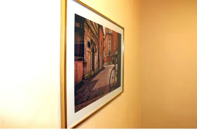 a picture hanging on a wall in a room at Apartament Izaaka in Kraków