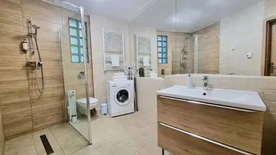 a bathroom with a sink and a washing machine at NOOK NOOK Apartments Kazimierza Wielkiego 104 in Kraków