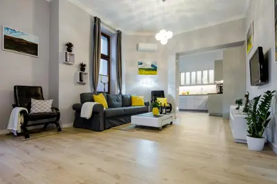 a living room with a couch and a table at Kings Landing Apartament in Kraków