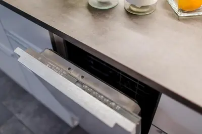 a kitchen counter with an oven under a counter top at Kings Landing Apartament in Kraków