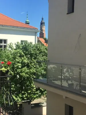 a balcony with a view of a building at Kings Landing Apartament in Kraków