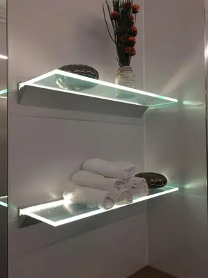 a shelf with towels and a vase on it at Kings Landing Apartament in Kraków