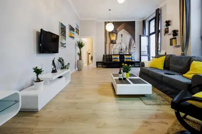 a living room with a couch and a table at Kings Landing Apartament in Kraków