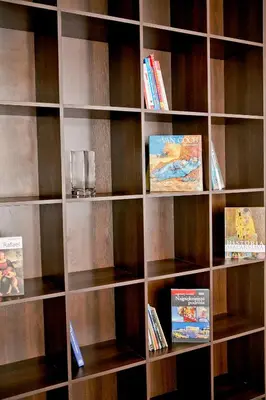 a book shelf filled with wooden shelves with books at Elegant City Center Zyblikiewicza 165 in Kraków
