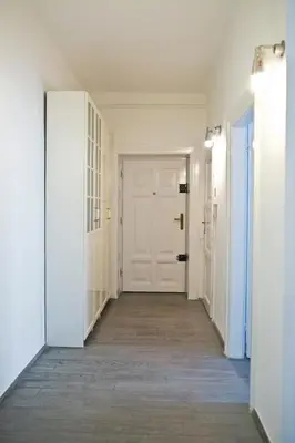 an empty hallway with white walls and a white door at Elegant City Center Zyblikiewicza 165 in Kraków