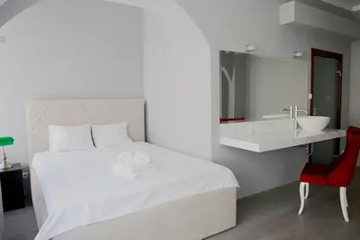 a bedroom with a white bed and a sink at Elegant City Center Zyblikiewicza 165 in Kraków