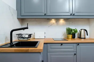 a kitchen with a sink and a counter top at P&J Luxury Apartments in Kraków