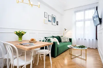 a living room with a green couch and a table at P&J Luxury Apartments in Kraków