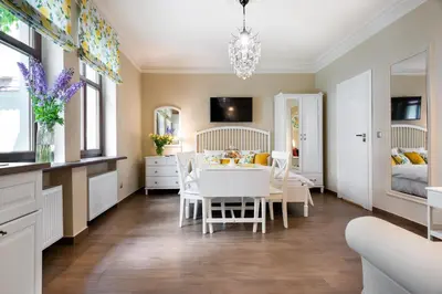 a kitchen and dining room with a table and chairs at P&J Luxury Apartments in Kraków