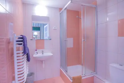 a bathroom with a shower and a sink at Finger Guest Rooms in Kraków