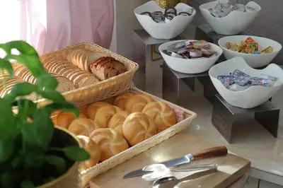 a bunch of breads and pastries in baskets on a table at Hotel Grand Felix in Kraków