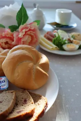 a plate with a sandwich and bread on a table at Hotel Grand Felix in Kraków
