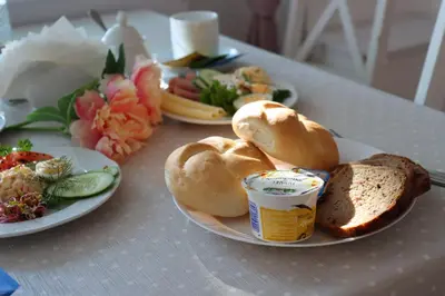 a table with plates of food and bread on it at Hotel Grand Felix in Kraków