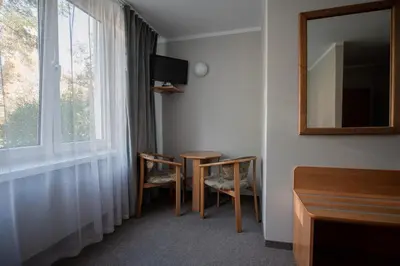 a room with a table and chairs and a window at Hotel Felix in Kraków