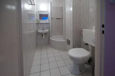 a bathroom with a toilet and a sink at Hotel Felix in Kraków