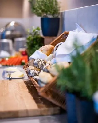 a basket of bread and other food on a table at Dosłońce Resort Wellness & Farm in Racławice