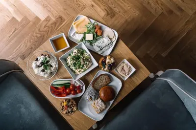 a table with many plates of food on it at Belle Epoque Residence in Kraków