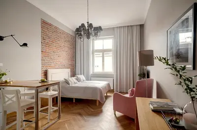 a living room with a table and a dining room at Belle Epoque Residence in Kraków