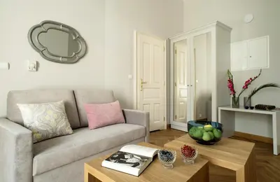 a living room with a couch and a coffee table at Belle Epoque Residence in Kraków