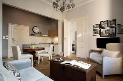 a living room with a couch and a table at Belle Epoque Residence in Kraków