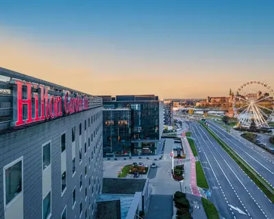 a view of a city with a ferris wheel at Hilton Garden Inn Krakow in Kraków
