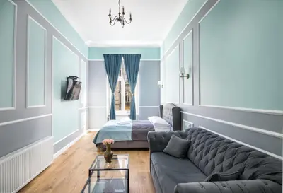 a living room with a couch and a bed at Domles Apartments in Kraków