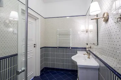 a bathroom with a sink and a mirror at Domles Apartments in Kraków