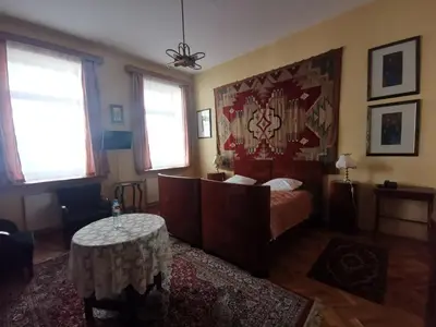 a bedroom with a bed and a table in it at Hotel Alef in Kraków