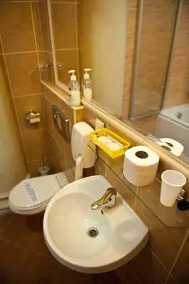 a bathroom with a sink and a toilet and a mirror at Hotel Alef in Kraków
