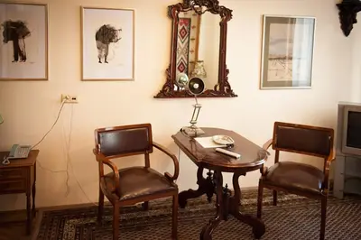 a room with a table and two chairs and a mirror at Hotel Alef in Kraków