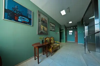 a hallway with a couch and a table in a building at Hotel Alef in Kraków