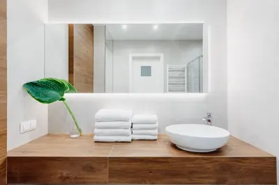 a bathroom with a white sink and a mirror at 4Seasons﻿ Apartments Cracow in Kraków