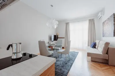 a kitchen and living room with a couch and a table at 4Seasons﻿ Apartments Cracow in Kraków