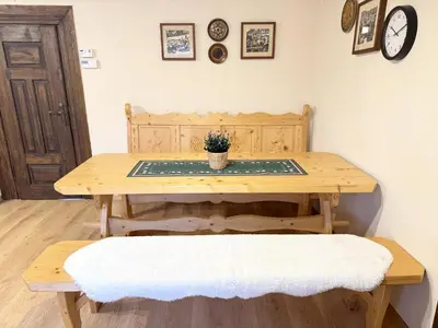 a wooden table and bench with a potted plant on it at Przystanek Rabka - Domek całoroczny in Rabka