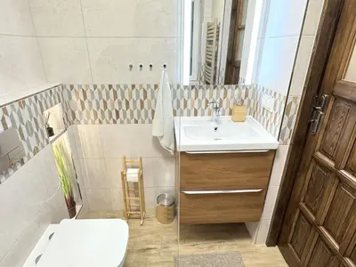 a bathroom with a sink and a toilet at Przystanek Rabka - Domek całoroczny in Rabka