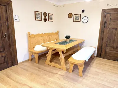 a wooden table with a bench and a table and chair at Przystanek Rabka - Domek całoroczny in Rabka