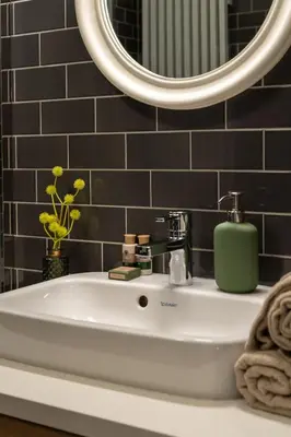 a bathroom with a sink and a mirror at Kokon Old Town in Kraków