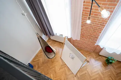 a room with a hammock on the floor next to a window at Kokon Old Town in Kraków