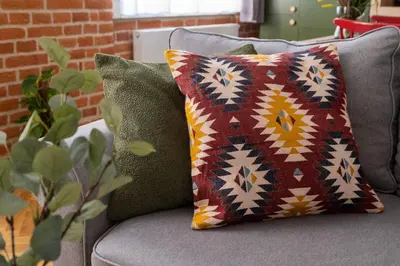 a couch with two pillows on it at Kokon Old Town in Kraków