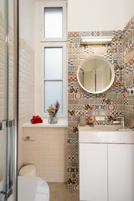 a bathroom with a sink and a mirror at Kokon Old Town in Kraków