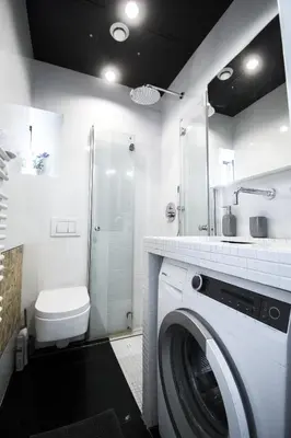 a washing machine in a bathroom with a shower at LION apartments - Gold in Kraków