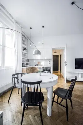 a kitchen with a table and chairs in a room at LION apartments - Gold in Kraków