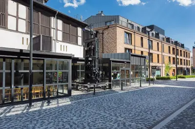 a cobblestone street in a city with buildings at InPoint Krakow Suites - Steps from Main Station&Old Town Self Check-in in Kraków
