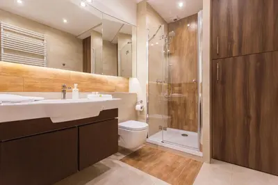 a bathroom with a shower and a sink and a toilet at InPoint Krakow Suites - Steps from Main Station&Old Town Self Check-in in Kraków