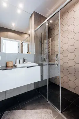 a bathroom with a glass shower and a sink at City Lights Topolowa 8 in Kraków