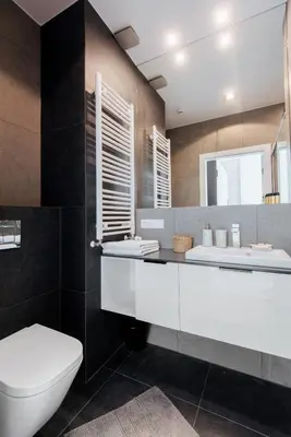 a bathroom with a white toilet and a sink at City Lights Topolowa 8 in Kraków