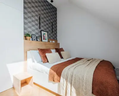 a bedroom with a large bed with a wooden headboard at City Lights Topolowa 8 in Kraków