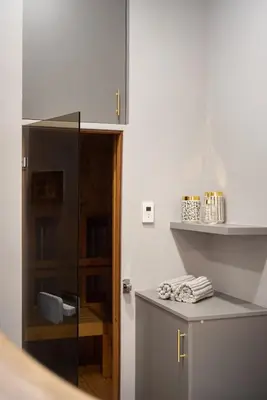 a kitchen with a counter and a glass door at Krakowhomes in Kraków